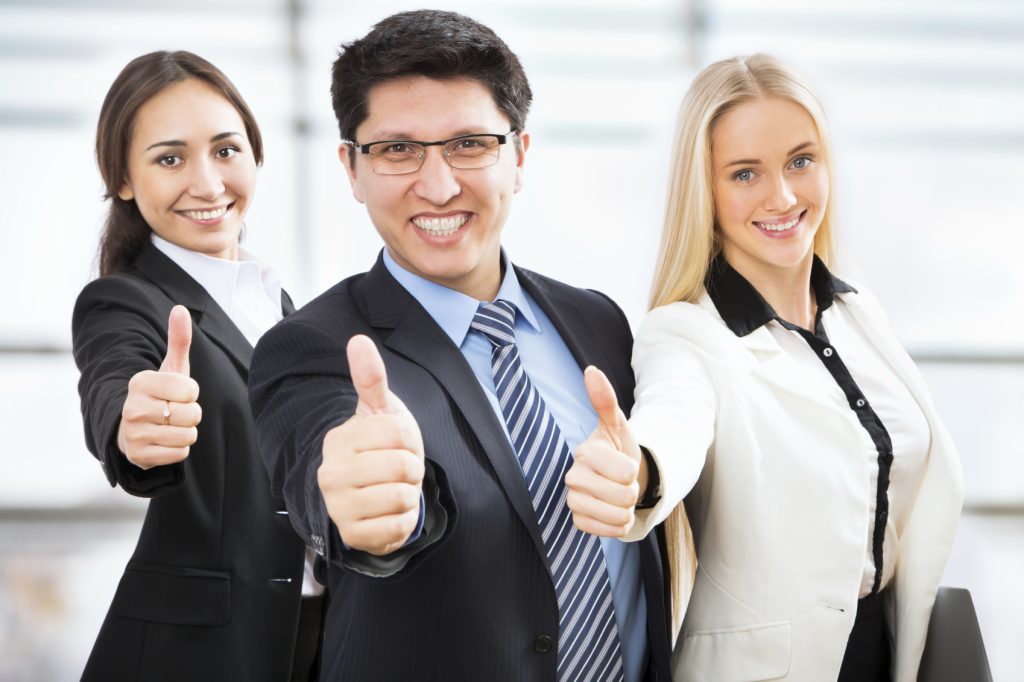 Happy business people show thumb up