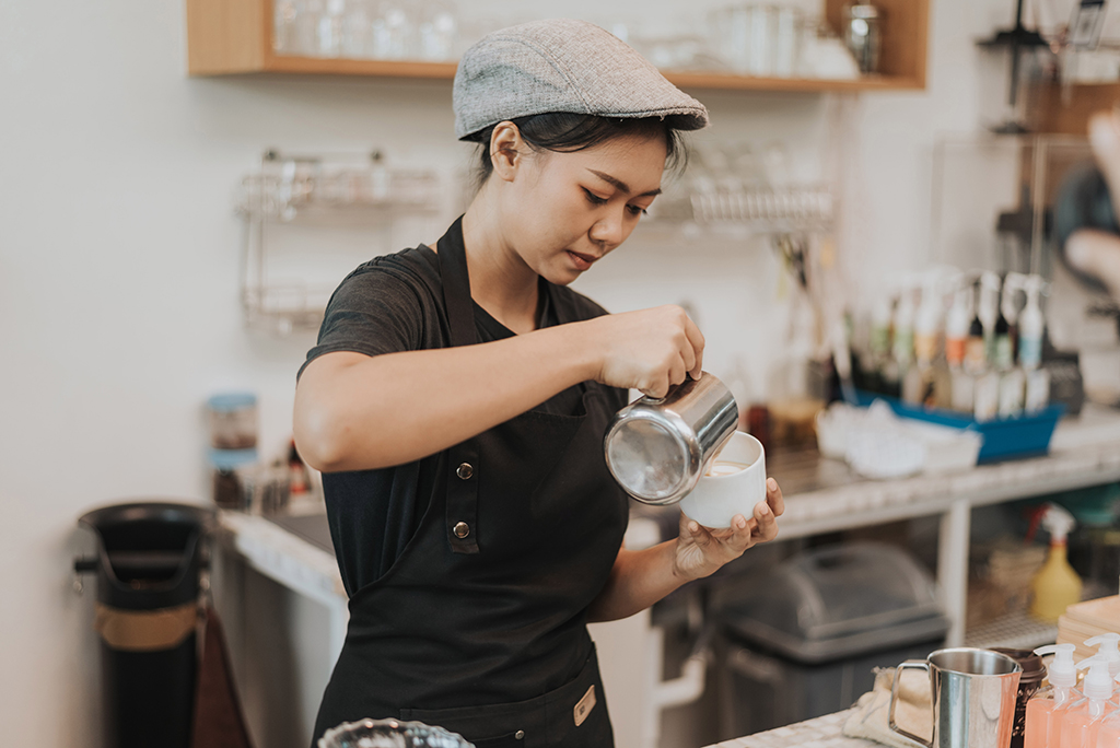 Female barista making coffee